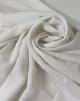 Very soft and light silk and acetate fabric with a crushed effect in white. Slightly transparent and flowy, perfect for blouses, shirting, dresses, and skirts. High-quality deadstock collected in Stock from a Maison de Couture in Italy.