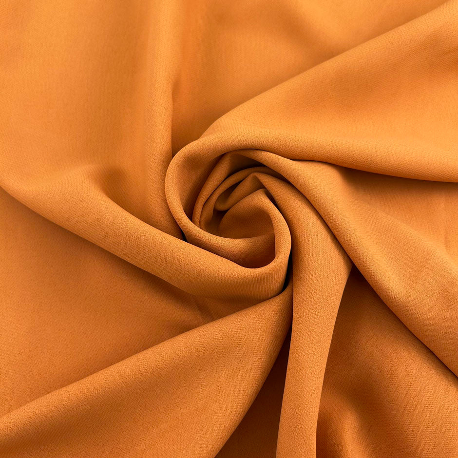 Dark yellow viscose cady crepe fabric with a soft hand, non-stretch constructionand not transparent. Ideal for creating trousers. High-quality deadstock collected in Stock from a Maison de Couture in Italy.