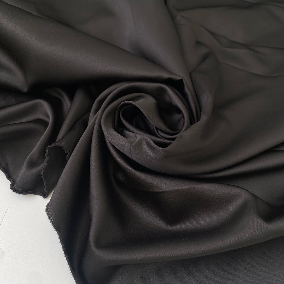 Brown matte polyester satin with a soft touch and elegant drape ideal for dresses skirts and linings. High-quality deadstock collected in Stock from a Maison de Couture in Italy.