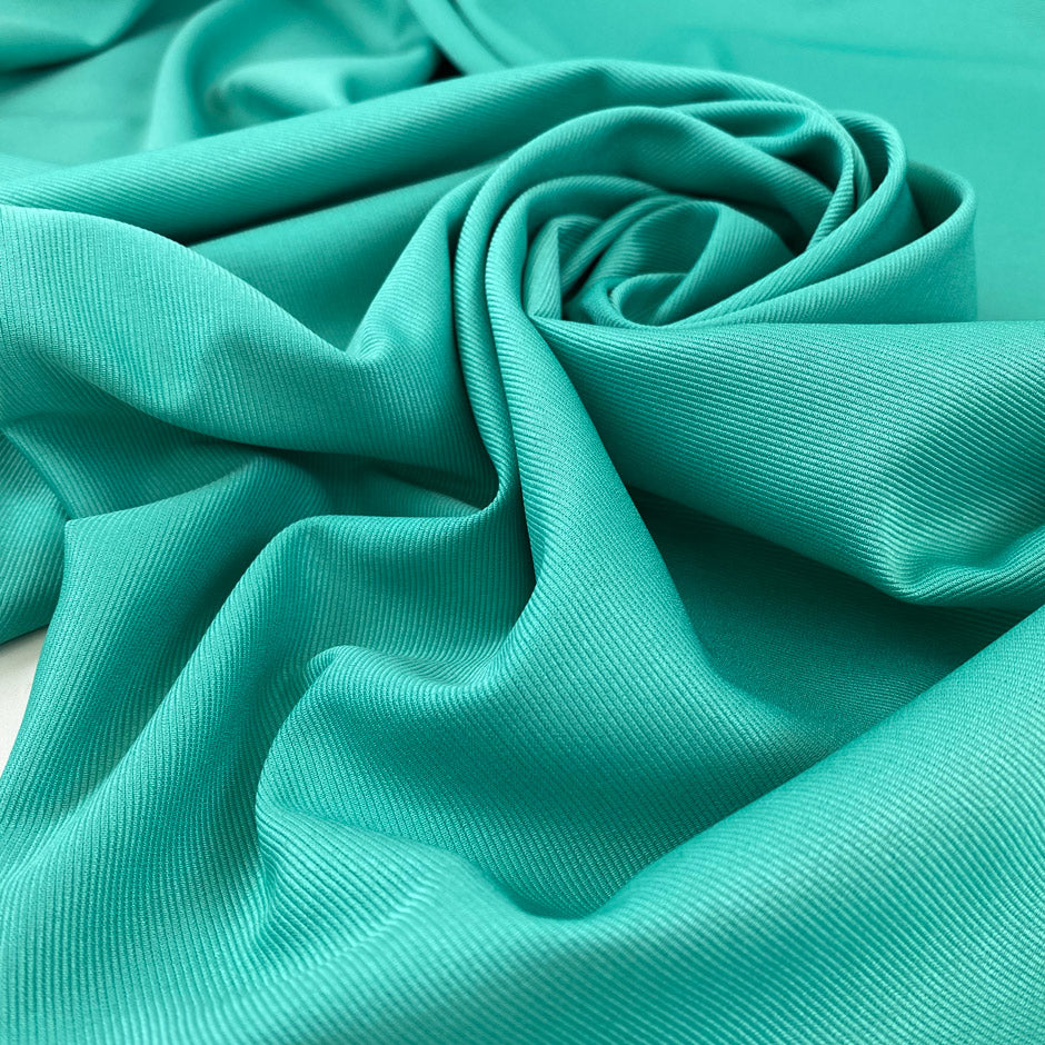 Polyester cady with ottoman texture in aqua green, structured and elegant. Ideal for dresses jackets and tailored pieces. High-quality deadstock collected in Stock from a Maison de Couture in Italy.