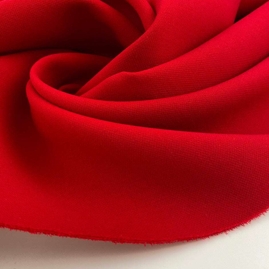Pure virgin wool double crepe fabric, red and textured. High quality deadstock fabric.