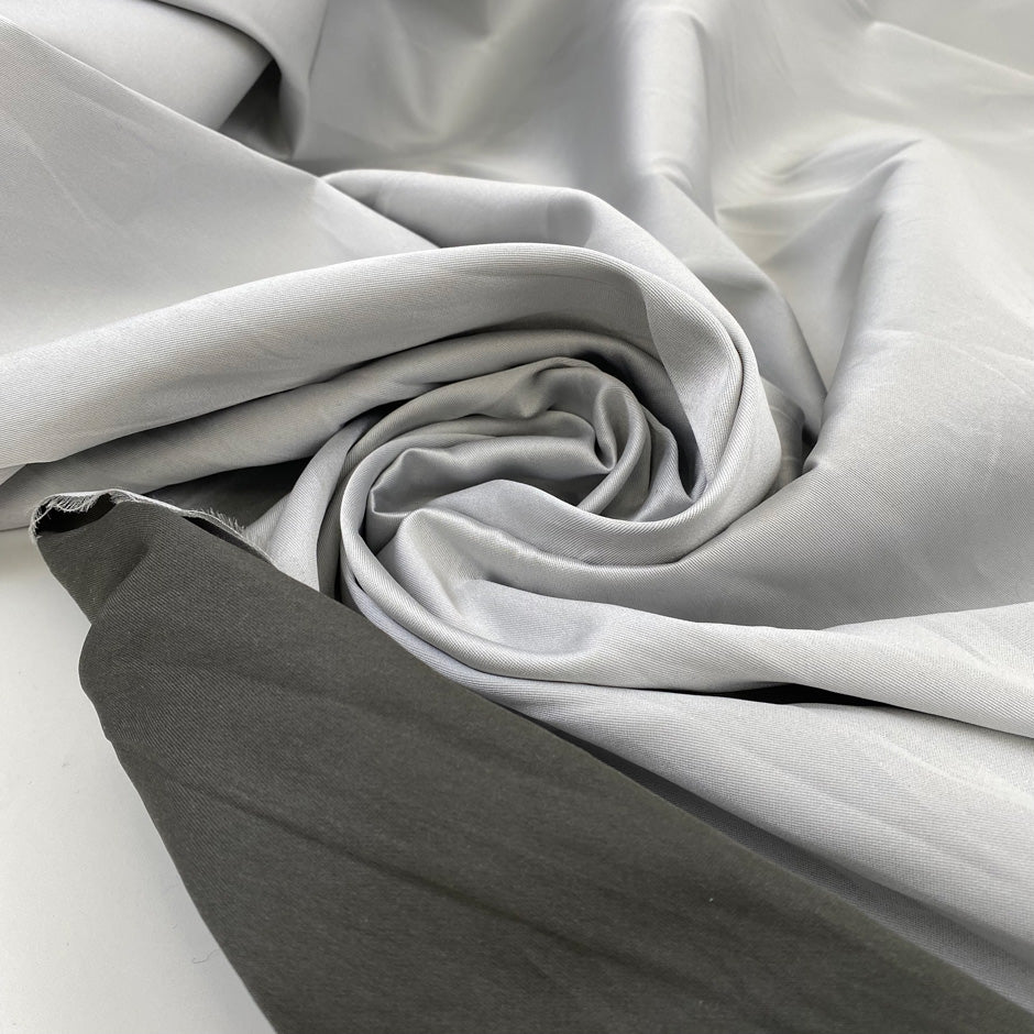 Silk and polyester Mikado double face, dark and light gray very soft. High-quality deadstock fabric collected in Stock from a Maison de Couture in Italy.