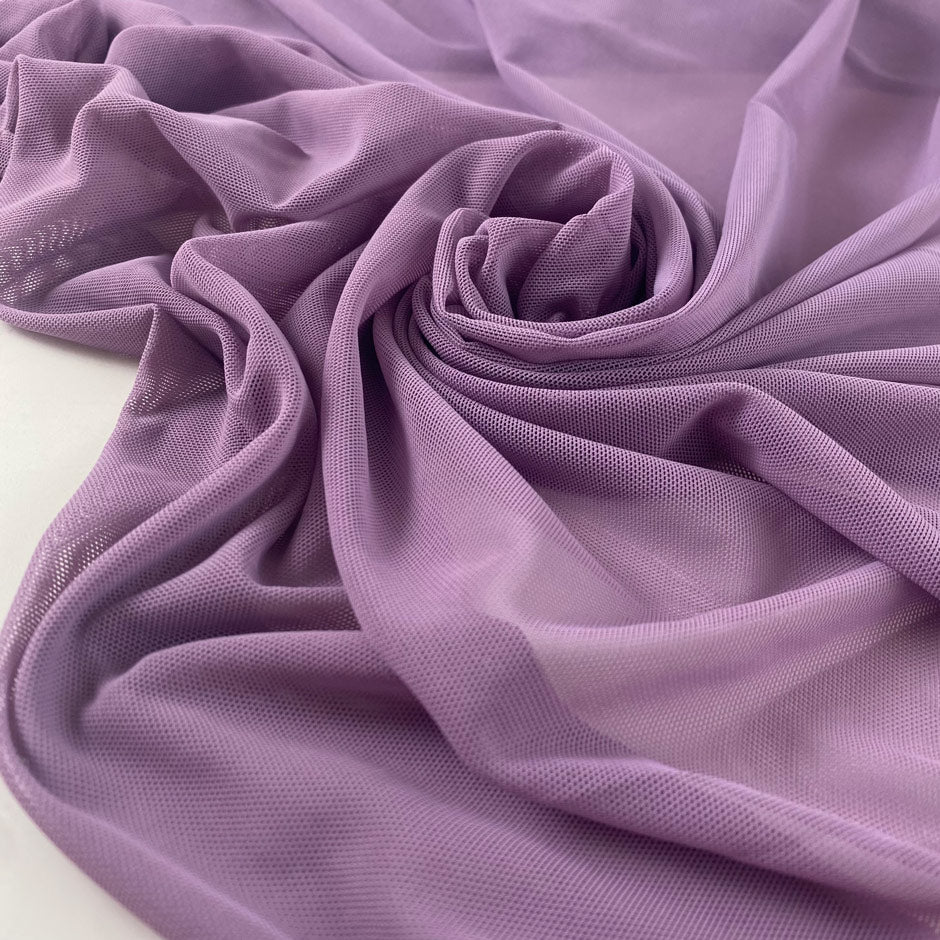 Stretch microtulle in regal orchid. Very light, transparent, flowy and soft – ideal for dresses, underwear, and t-shirts. High-quality deadstock collected in Stock from a Maison de Couture in Italy.