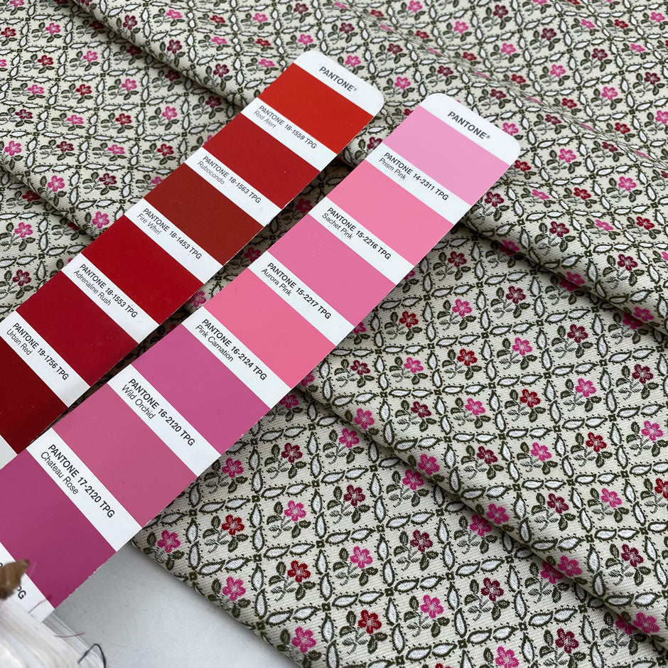 Brocade with a very small floral design, the ground is ivory and green with pink carnation and urban red flowers. Soft and structured, ideal for skirts, trousers, and jackets. High-quality deadstock fabric by the meter collected in Stock from a Maison de Couture in Italy.