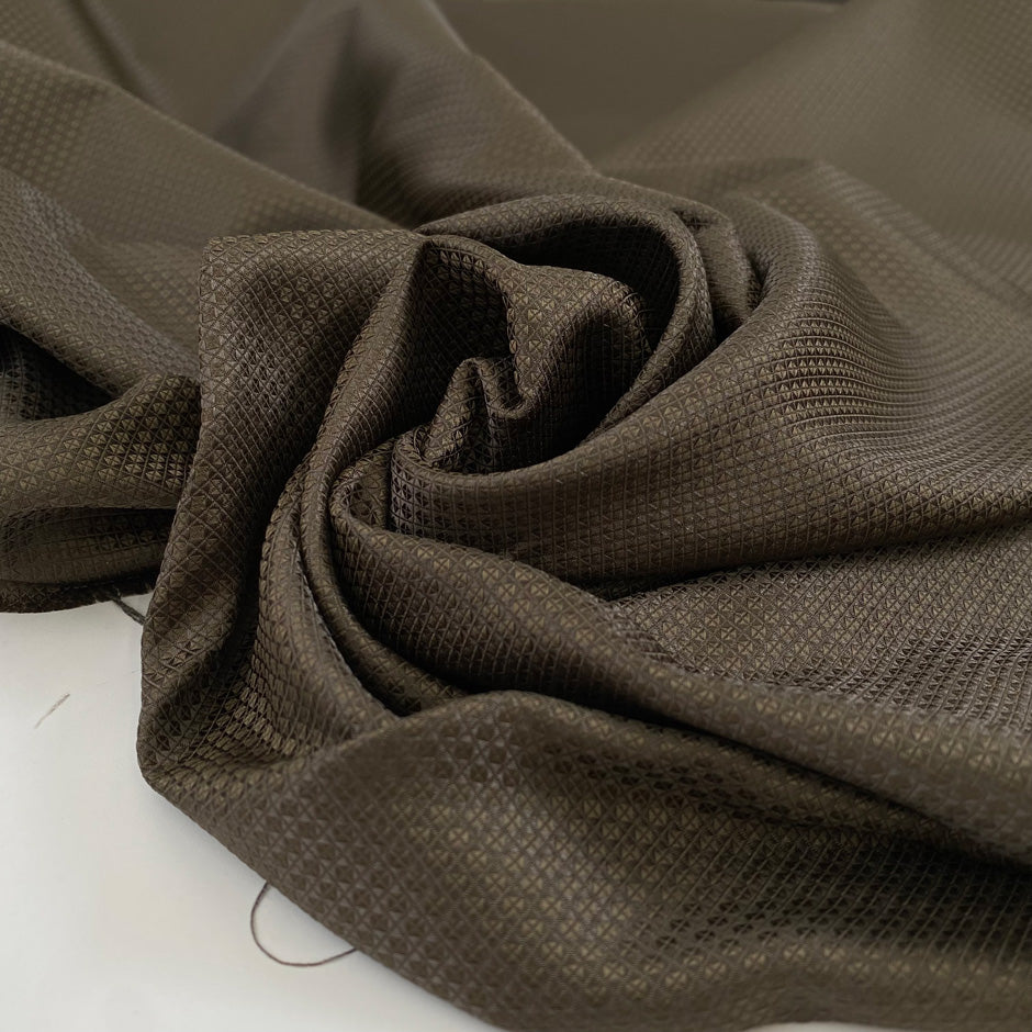 Polyester jacquard in dark brown with an ultra-small pattern, very soft, light, and slightly shiny, ideal for dresses, shirts, and fluid tailoring. High-quality deadstock collected in Stock from a Maison de Couture in Italy.