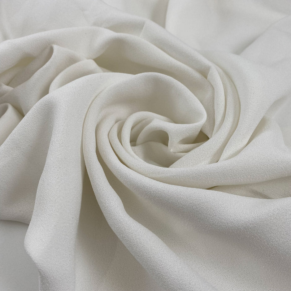 Pure viscose crepe cady in white, very soft, light, and flowy. Just a bit transparent. High-quality deadstock fabric collected in Stock from a Maison de Couture in Italy.