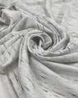 Cotton jersey with melange design in shades of white, gray, and black. Very soft, warm and light. High-quality deadstock fabric collected in Stock from a Maison de Couture in Italy.