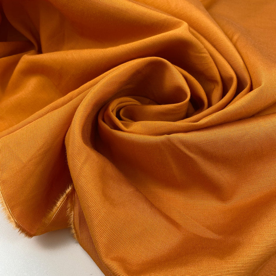 Pure viscose in apricot orange very soft, light, and flowy. High-quality deadstock fabric by the meter collected in Stock from a Maison de Couture in Italy.