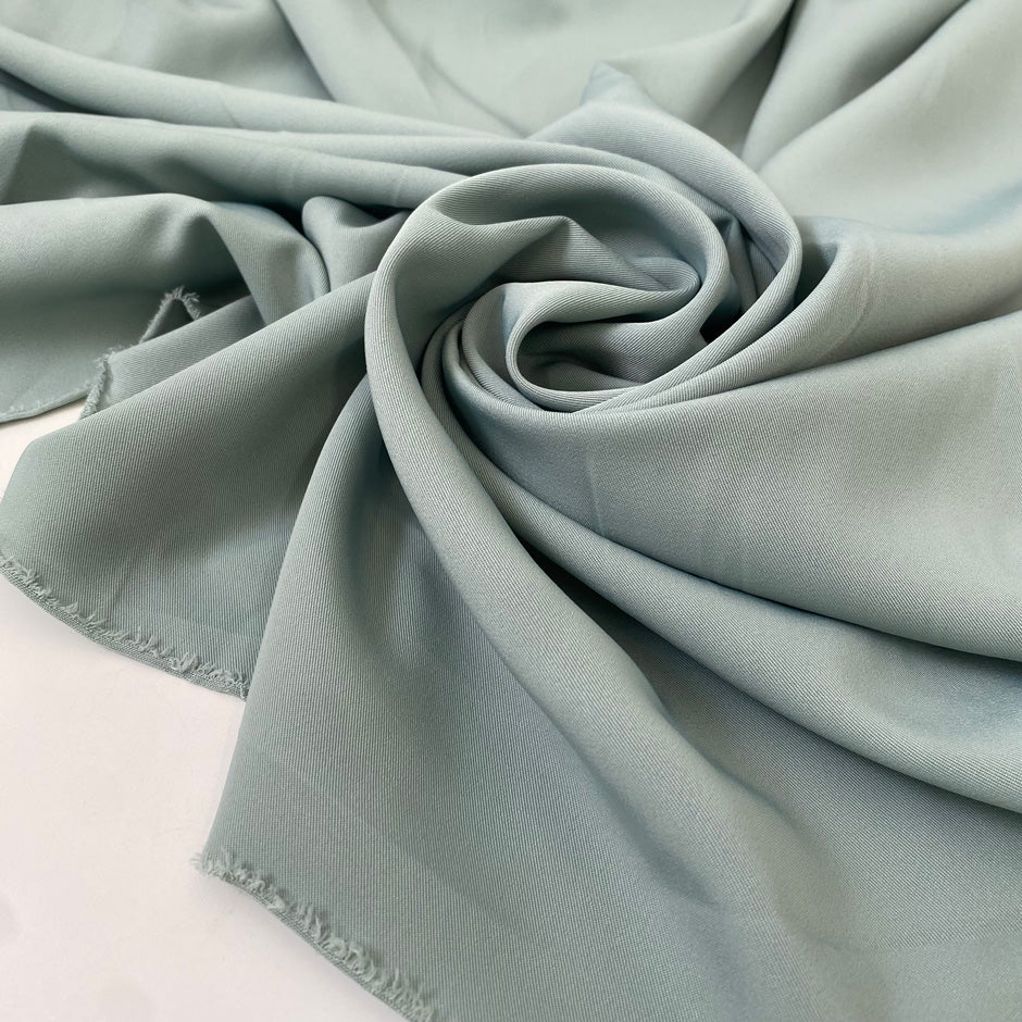 Polyester cady in sage color. Very soft, light, flowy, and not transparent. Ideal for trousers, dresses, and skirts. High-quality deadstock collected in Stock from a Maison de Couture in Italy.