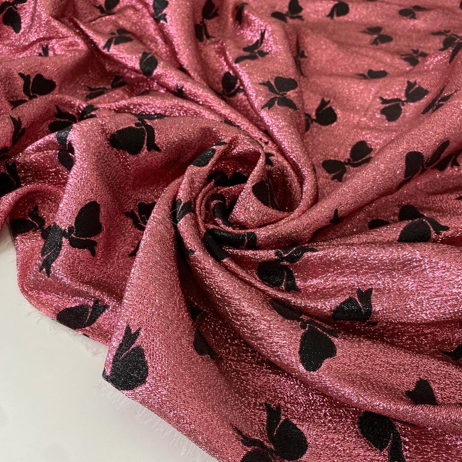 Silk and lurex fabric in pink with black bow print. Very soft and light, flowy and sparkling, not transparent. Ideal for dresses, skirts, blouses, and shirting. High-quality deadstock collected in Stock from a Maison de Couture in Italy.