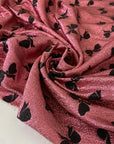 Silk and lurex fabric in pink with black bow print. Very soft and light, flowy and sparkling, not transparent. Ideal for dresses, skirts, blouses, and shirting. High-quality deadstock collected in Stock from a Maison de Couture in Italy.