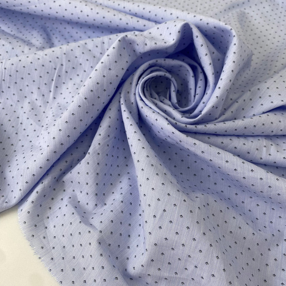Pure cotton in light blue with a small geometric design, color reference Heather. Very soft and light, not transparent. Ideal for shirting, dresses, or skirts. High-quality deadstock collected in Stock from a Maison de Couture in Italy.
