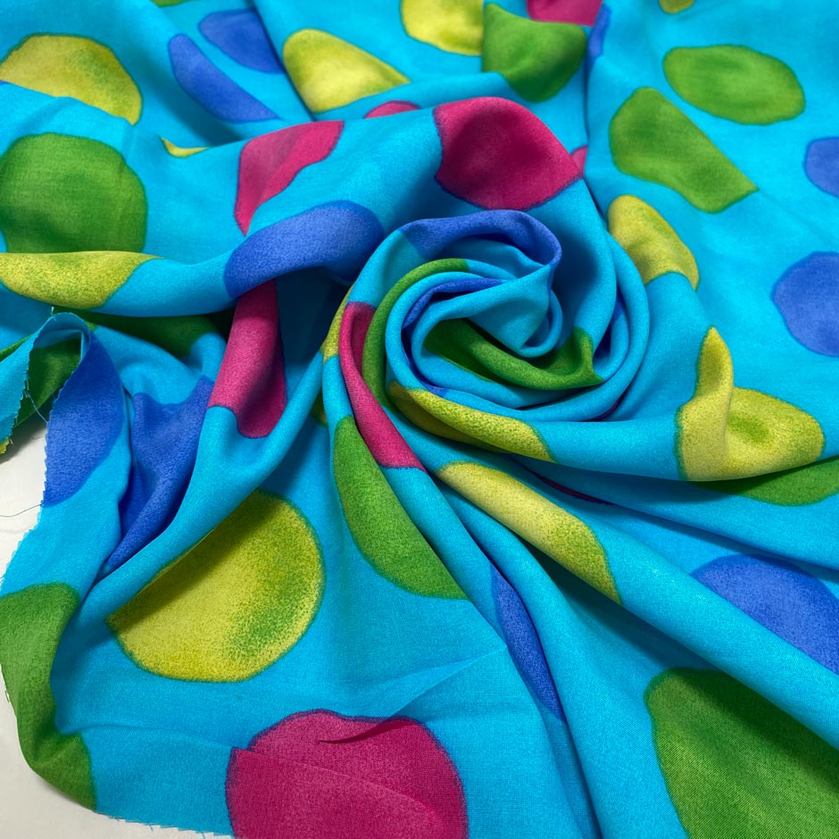 Soft and lightweight pure viscose with a turquoise base and large multicolor polka dots. Flowy and not transparent, ideal for dresses, skirts, trousers, and blouses.High-quality deadstock collected in Stock from a Maison de Couture in Italy.