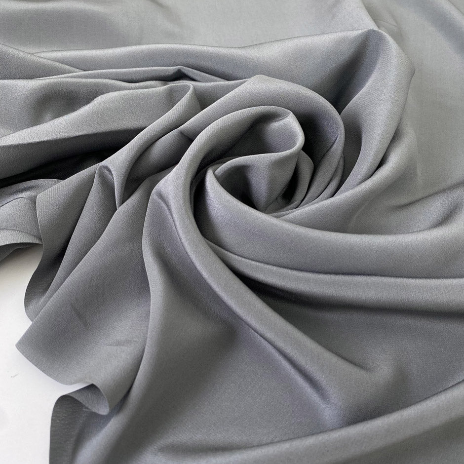 Pure silk crepe de chine in goth gray. Very soft and light, flowy, and not transparent. Ideal for shirting, blouses, dresses, and skirts. High-quality deadstock collected in Stock from a Maison de Couture in Italy.