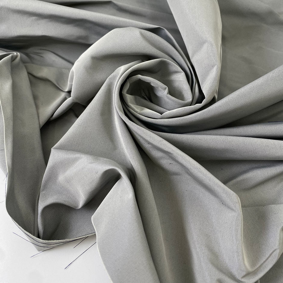 Polyester and silk taffeta in gray color reference drizzle. Stiff and voluminous, ideal for shirting, dresses, skirts, and jackets. High-quality deadstock collected in Stock from a Maison de Couture in Italy.