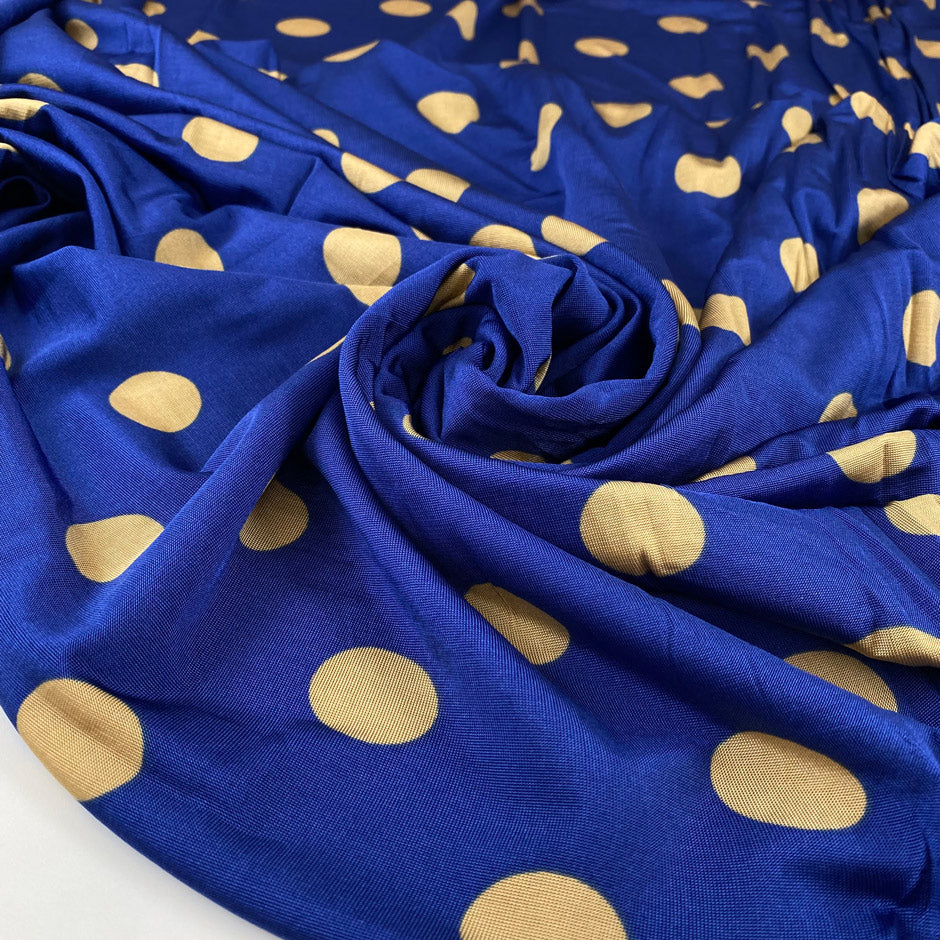 Pure and cold viscose jersey in blue, polka dots design in mustard. Bi-stretch, soft and light. High-quality deadstock fabric collected in Stock from a Maison de Couture in Italy.