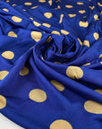 Pure and cold viscose jersey in blue, polka dots design in mustard. Bi-stretch, soft and light. High-quality deadstock fabric collected in Stock from a Maison de Couture in Italy.