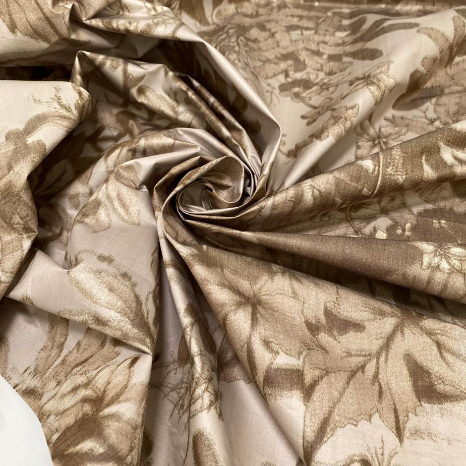 Stiff viscose and polyester taffeta printed with a jungle leaf design in sand and beige shades. Adds volume and holds shape, ideal for skirts, trench coats, and dresses.&nbsp;High-quality deadstock collected in Stock from a Maison de Couture in Italy.
