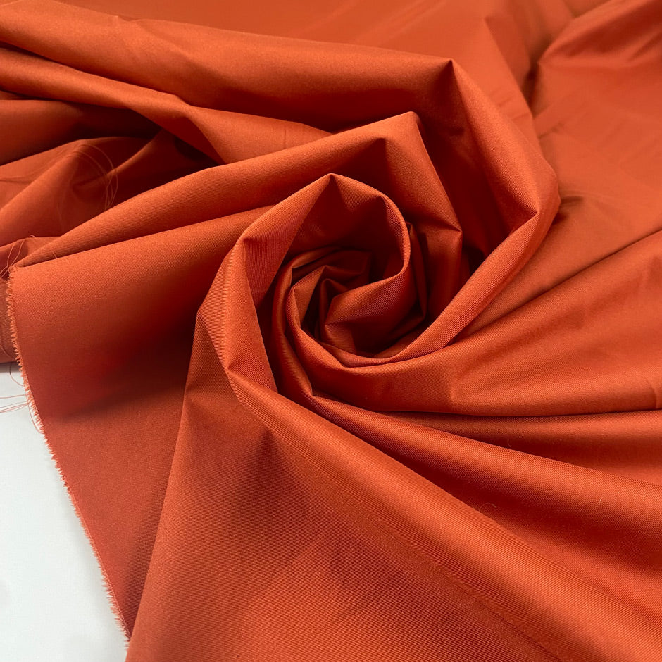 Light stretch nylon in spice route color, very light and flowy. Ideal for raincoats and jackets. High-quality deadstock collected in Stock from a Maison de Couture in Italy.