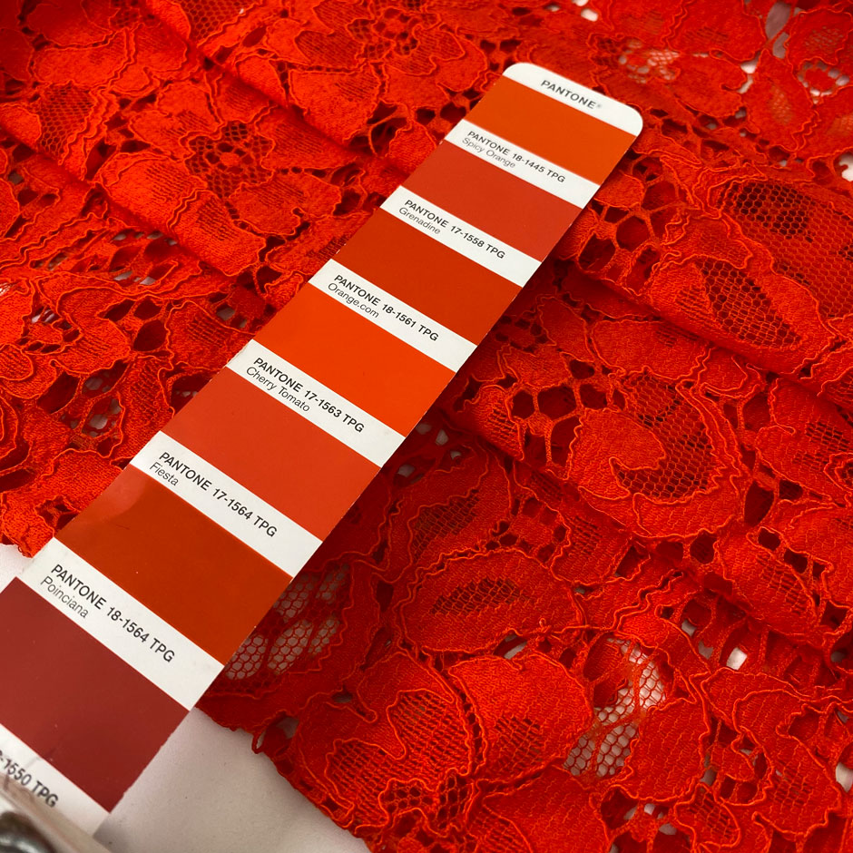 Cotton and polyester lace in tomato red with a delicate flower design, soft and light. Ideal for dresses, blouses, and skirts. High-quality deadstock collected in Stock from a Maison de Couture in Italy.