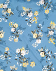 Light blue twill polyester in white and yellow floral design. The fabric is shiny and falling. High-quality deadstock fabric collected in Stock from a Maison de Couture in Italy.