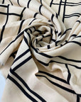 Pure viscose in light peach with a black geometric design. Very soft, flowy, and not transparent. Ideal for dresses, skirts, blouses, and shirting. High-quality deadstock collected in Stock from a Maison de Couture in Italy.