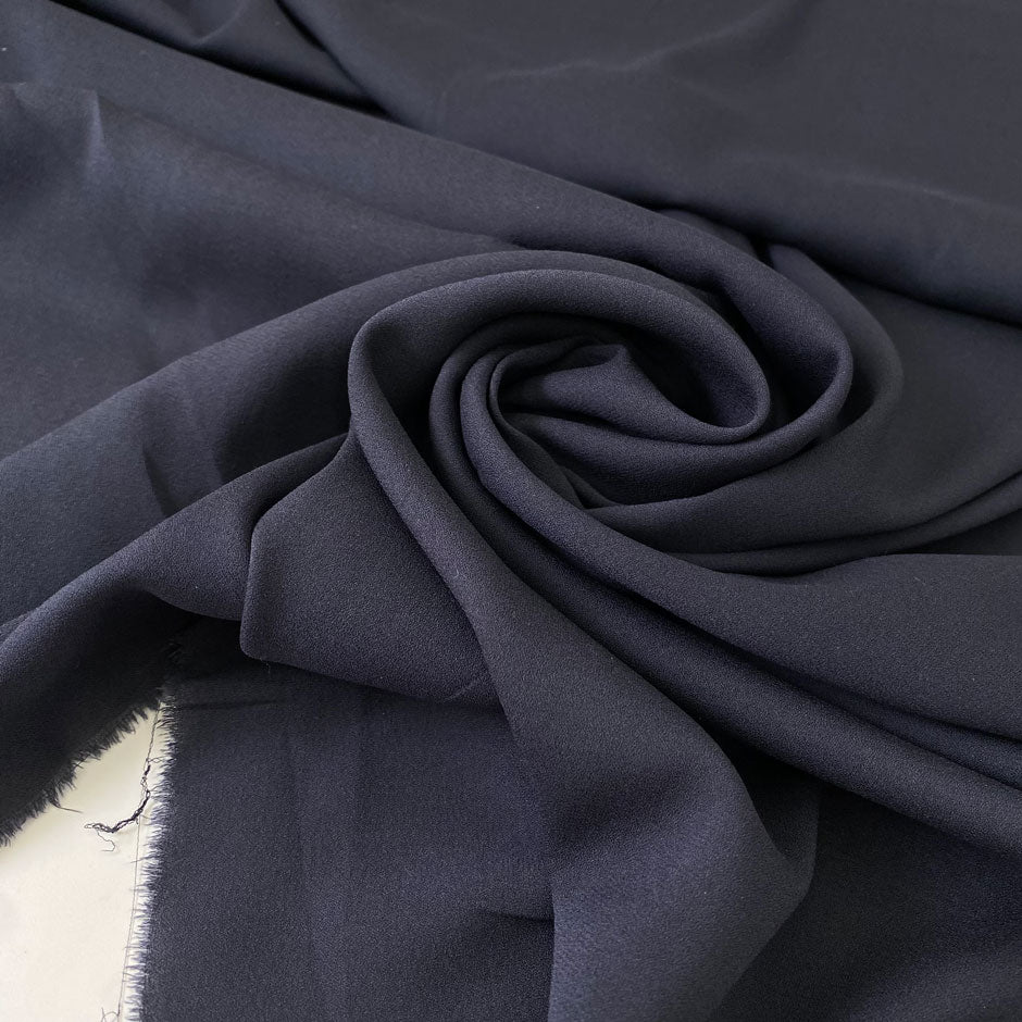 Soft and lightweight elasticized silk georgette in dark blue with slight transparency. Ideal for dresses, skirts, blouses, and shirting.
High-quality deadstock collected in Stock from a Maison de Couture in Italy.