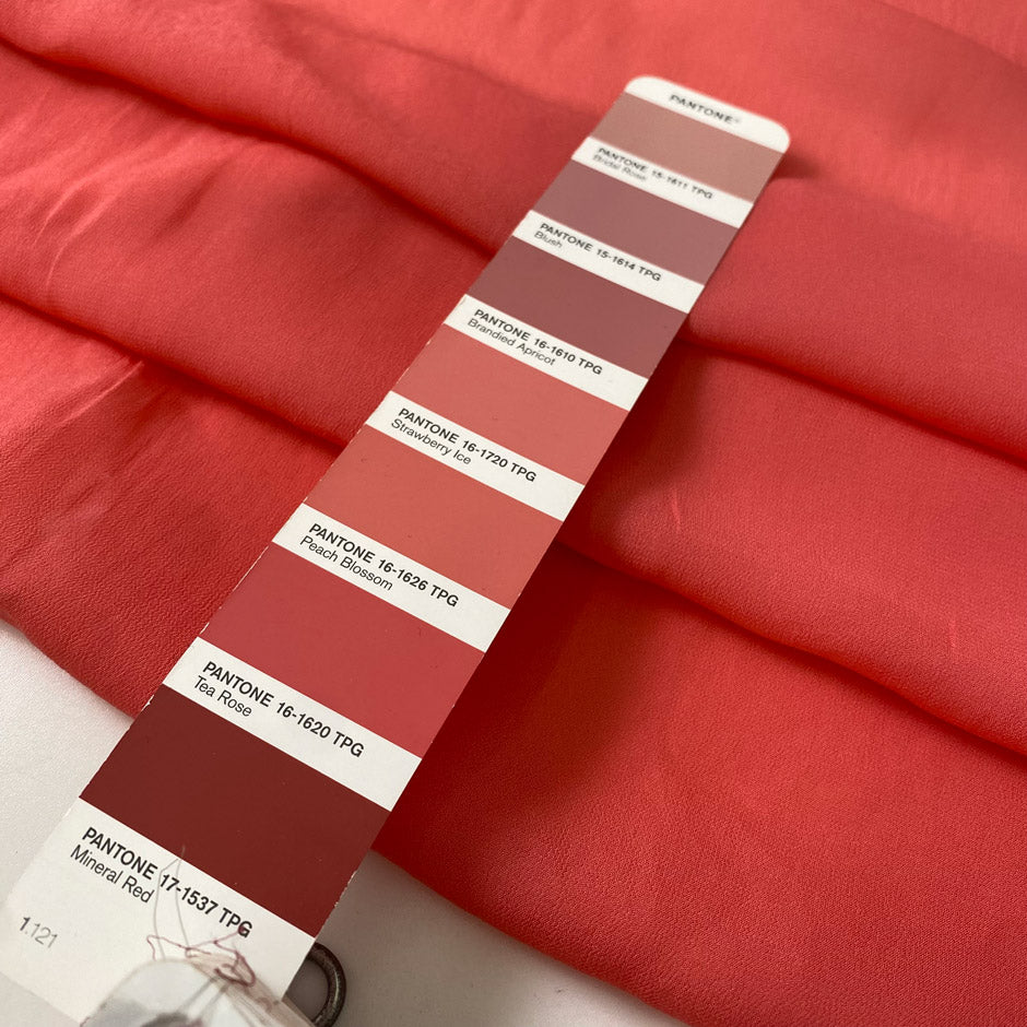 Light and soft viscose georgette in a coral shade. Slightly transparent with an elegant drape, perfect for skirts, blouses, shirting, and dresses. High-quality deadstock collected in Stock from a Maison de Couture in Italy.