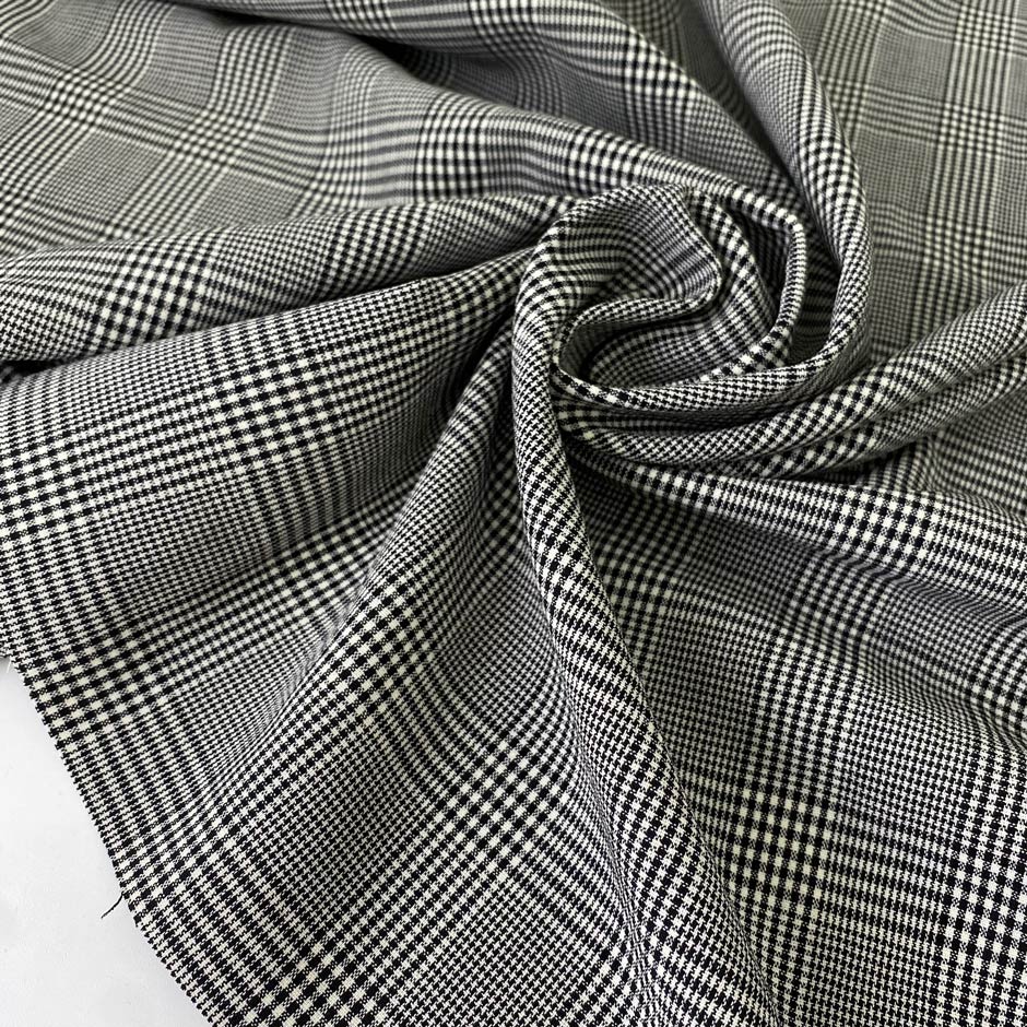 Soft stretch wool with a classic Prince of Wales design in black and white. Perfect for trousers, dresses, skirts, and jackets.High-quality deadstock collected in Stock from a Maison de Couture in Italy.