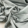 Cotton and polyester taffeta in Mirage Gray with a textured finish. Slightly stiff and shape-retaining, ideal for jackets, skirts, and dresses. High-quality deadstock collected in Stock from a Maison de Couture in Italy.