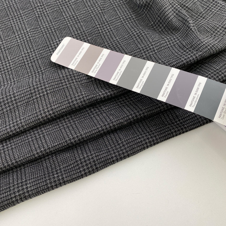 Gray jersey of viscose Punto Milano printed Prince of Wales. High-quality deadstock fabric collected in Stock from a Maison de Couture in Italy.