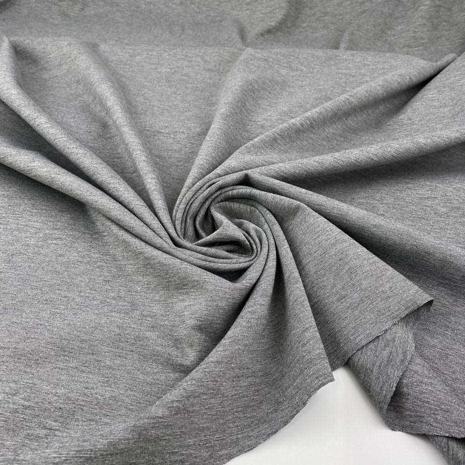 Milano stitch of soft and compact viscose-polyamide blend with grey melange weave. High quality deadstock fabric.