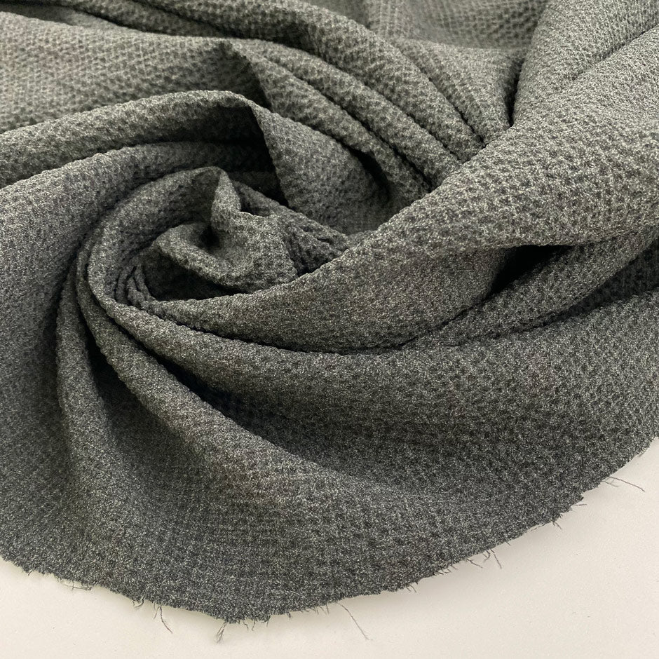 Light gray polyester seersucker with a crisp, puckered texture. Perfect for airy, wrinkle-resistant garments. High-quality deadstock collected in Stock from a Maison de Couture in Italy.