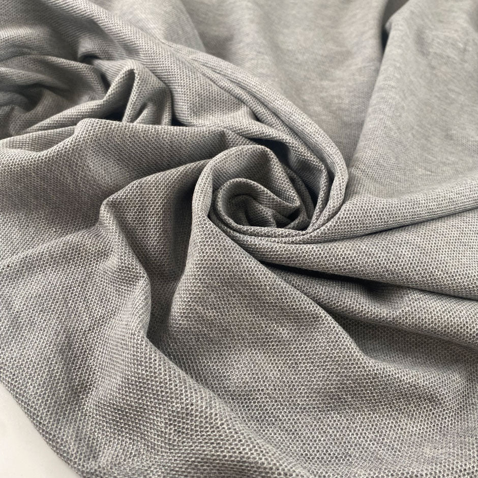 Stretch fabric with textured surface in light gray color reference Quiet Gray. Very soft and light, ideal for t-shirts and dresses. High-quality deadstock collected in Stock from a Maison de Couture in Italy.