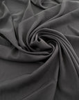 Crêpe de chine in gray silk, stretch and semitrasparent. High-quality fabric deadstock.