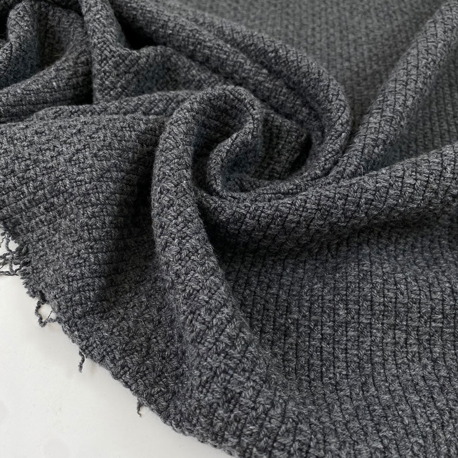 Wool and polyester tweed in smoked pearl grey. Very soft, flowy and medium weight. Ideal for light coats and jackets. High-quality deadstock collected in Stock from a Maison de Couture in Italy.