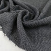 Wool and polyester tweed in smoked pearl grey. Very soft, flowy and medium weight. Ideal for light coats and jackets. High-quality deadstock collected in Stock from a Maison de Couture in Italy.
