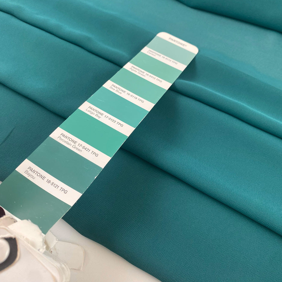 Polyester georgette in green color reference Bayou. Very soft, light, and transparent. Ideal for dresses, skirts, blouses, and shirting. High-quality deadstock collected in Stock from a Maison de Couture in Italy.