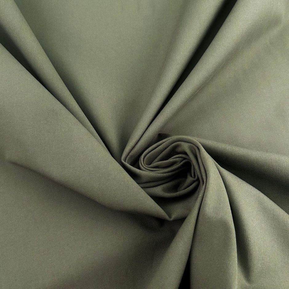 Green bielastic cotton gabardine, ideal for trousers. High-quality deadstock collected in Stock from a Maison de Couture in Italy.