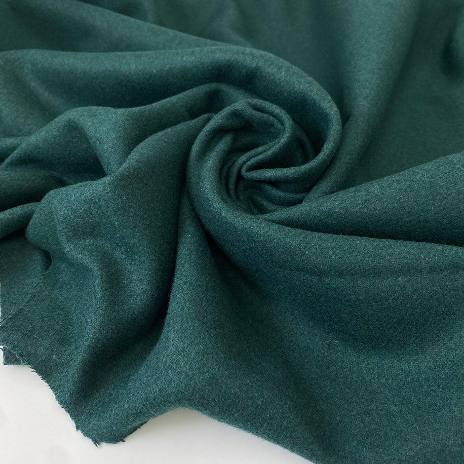 Heavy wool and polyester mix in dark green, shade Posy green. Very soft and warm, ideal for jackets and coats. High-quality deadstock collected in Stock from a Maison de Couture in Italy.