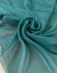 Polyester georgette in green color reference Bayou. Very soft, light, and transparent. Ideal for dresses, skirts, blouses, and shirting. High-quality deadstock collected in Stock from a Maison de Couture in Italy.