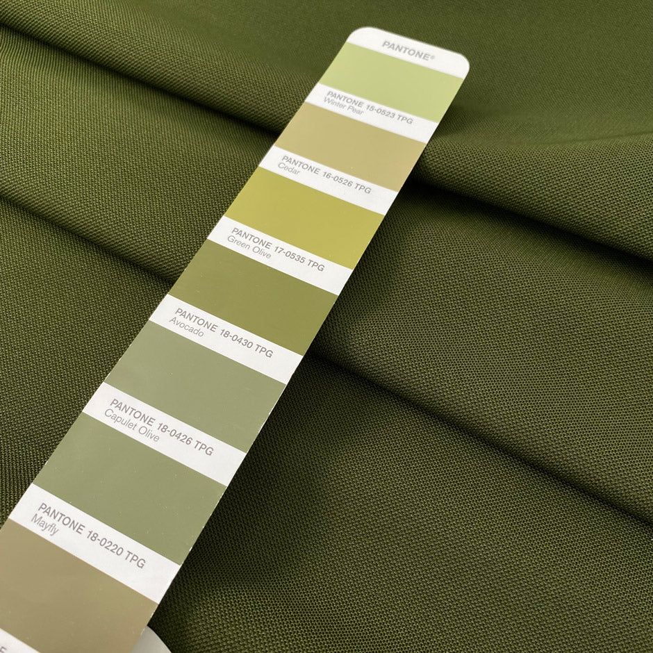 Dark green stretch Punto Milano jersey in polyester and elastane in the shade avocado, slightly heavy and stiff, with a rough texture. Ideal for trousers, skirts, dresses and jackets. High-quality deadstock collected in Stock from a Maison de Couture in Italy.