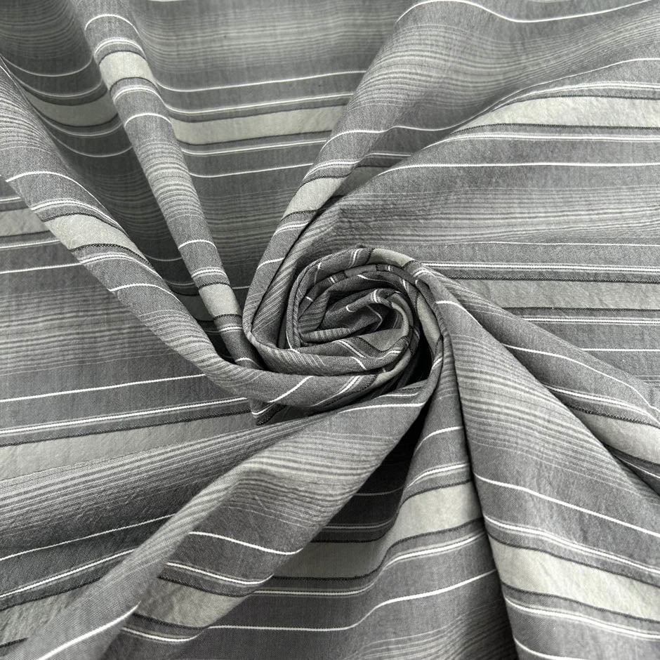 Gray striped cotton jacquard with an irregular pattern, soft and non-stretch. High-quality deadstock collected in Stock from a Maison de Couture in Italy.