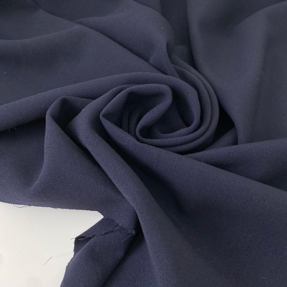 Heavy and flowing wool blend with stretch in dark blue. Ideal for structured yet elegant skirts, trousers, jackets, and dresses.High-quality deadstock collected in Stock from a Maison de Couture in Italy.