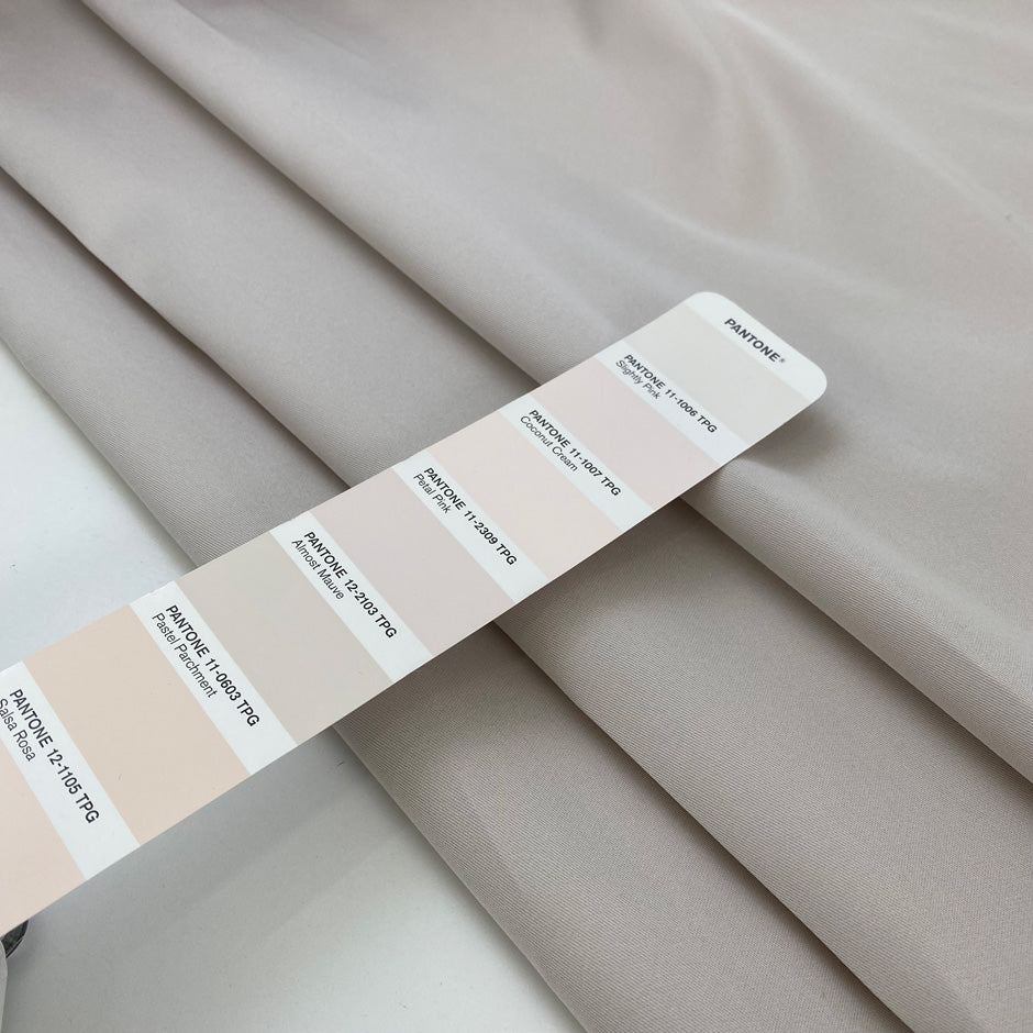 Double-face mikado in polyester and silk with pale rose tones, structured and elegant, ideal for dresses, skirts, and formal jackets. High-quality deadstock collected in Stock from a Maison de Couture in Italy.