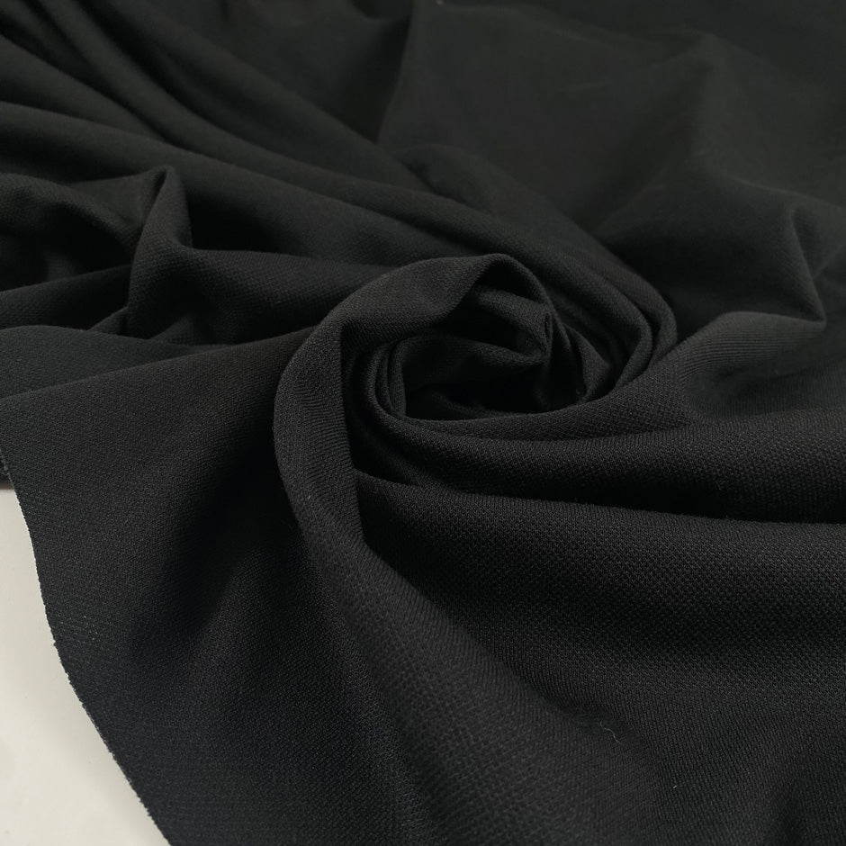 Black polyester jersey soft breathable versatile fabric ideal for everyday garments and activewear. High-quality deadstock collected in Stock from a Maison de Couture in Italy.