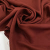 Pure viscose, very soft, light, and flowy in cinnabar dark red. Ideal for skirts, blouses, shirts, and dresses. High-quality deadstock fabric by the meter collected in Stock from a Maison de Couture in Italy.