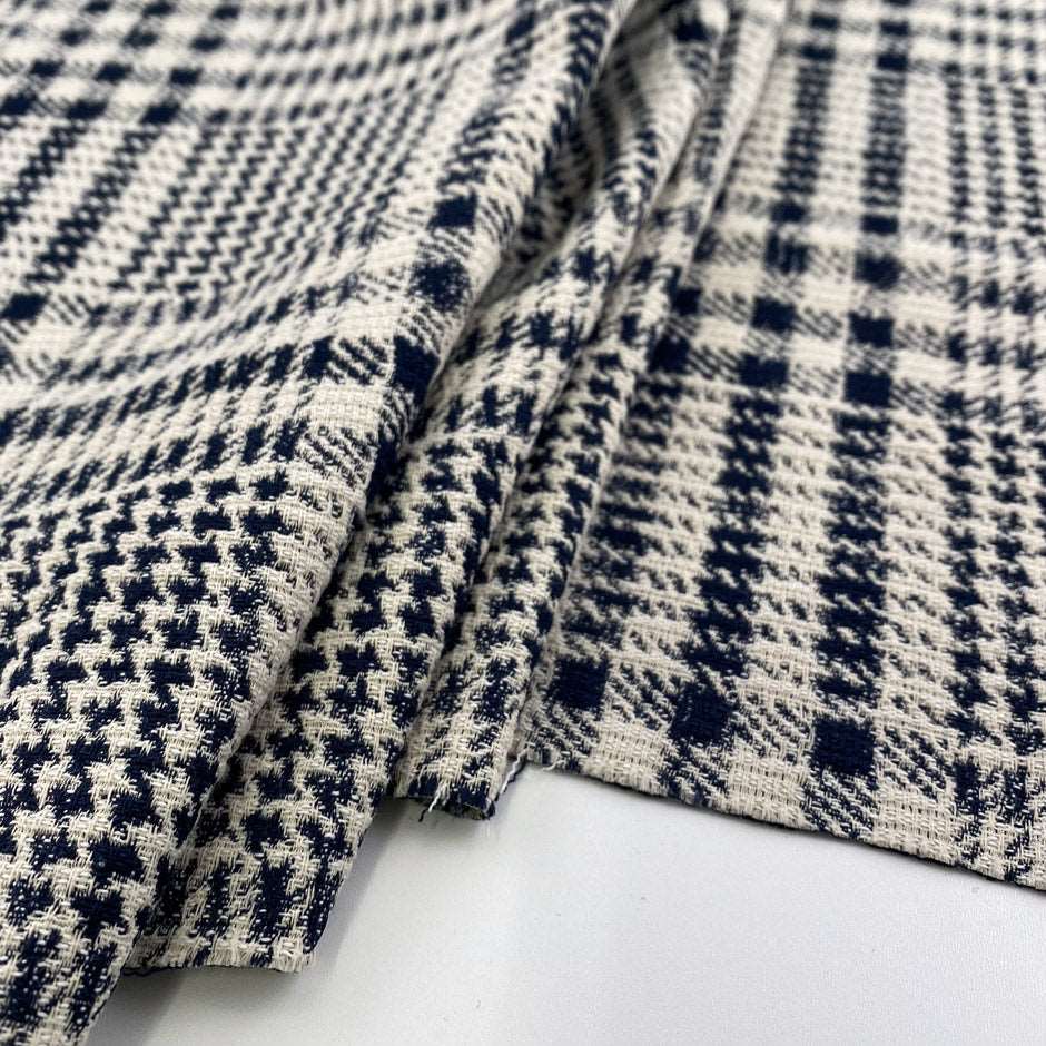 Stretch cotton-polyester blend with jacquard Prince of Wales pattern and blue and white double face. High quality deadstock fabric.