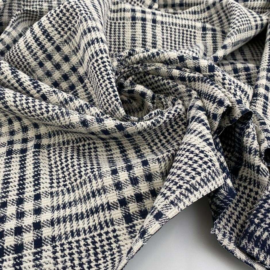 Stretch cotton-polyester blend with jacquard Prince of Wales pattern and blue and white double face. High quality deadstock fabric.