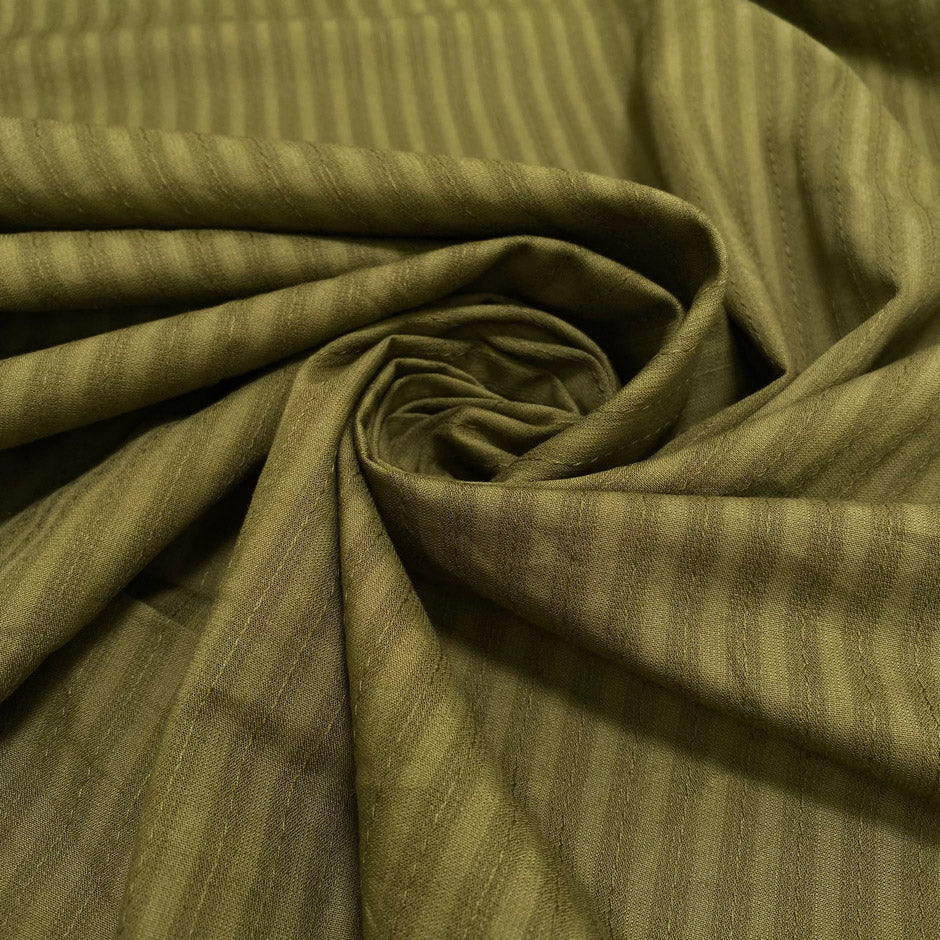 Pure cotton jacquard in avocado green with refined stripe design. Versatile and elegant, ideal for dresses, skirts, and trousers.&nbsp;High-quality deadstock collected in Stock from a Maison de Couture in Italy.